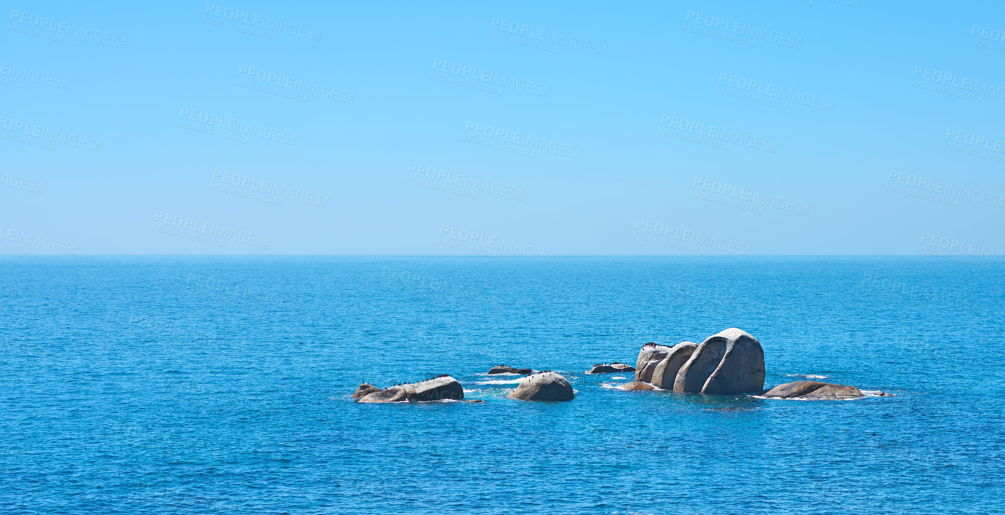 Buy stock photo Ocean, rocks and travel in outdoor nature, destination and peace in environment on sea vacation. Water, stone and calm beach on weekend trip, tropical island and holiday wallpaper of Bali skyline