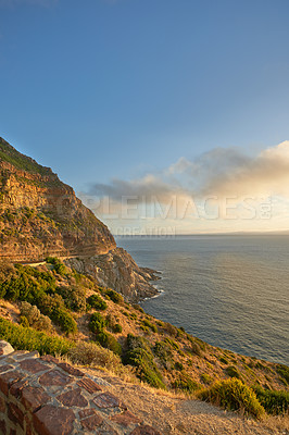 Buy stock photo Mountain, ocean and sunset landscape with sky and horizon for peace, travel destination and holiday location. Coastline, evening and sea water for tropical landscape, skyline and peace in nature