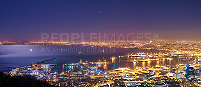 Buy stock photo Night, urban and buildings or cityscape and ocean for travel, skyline and development. Architecture, skyscraper and hospitality or outdoor with horizon or landscape for business and nature or hotel