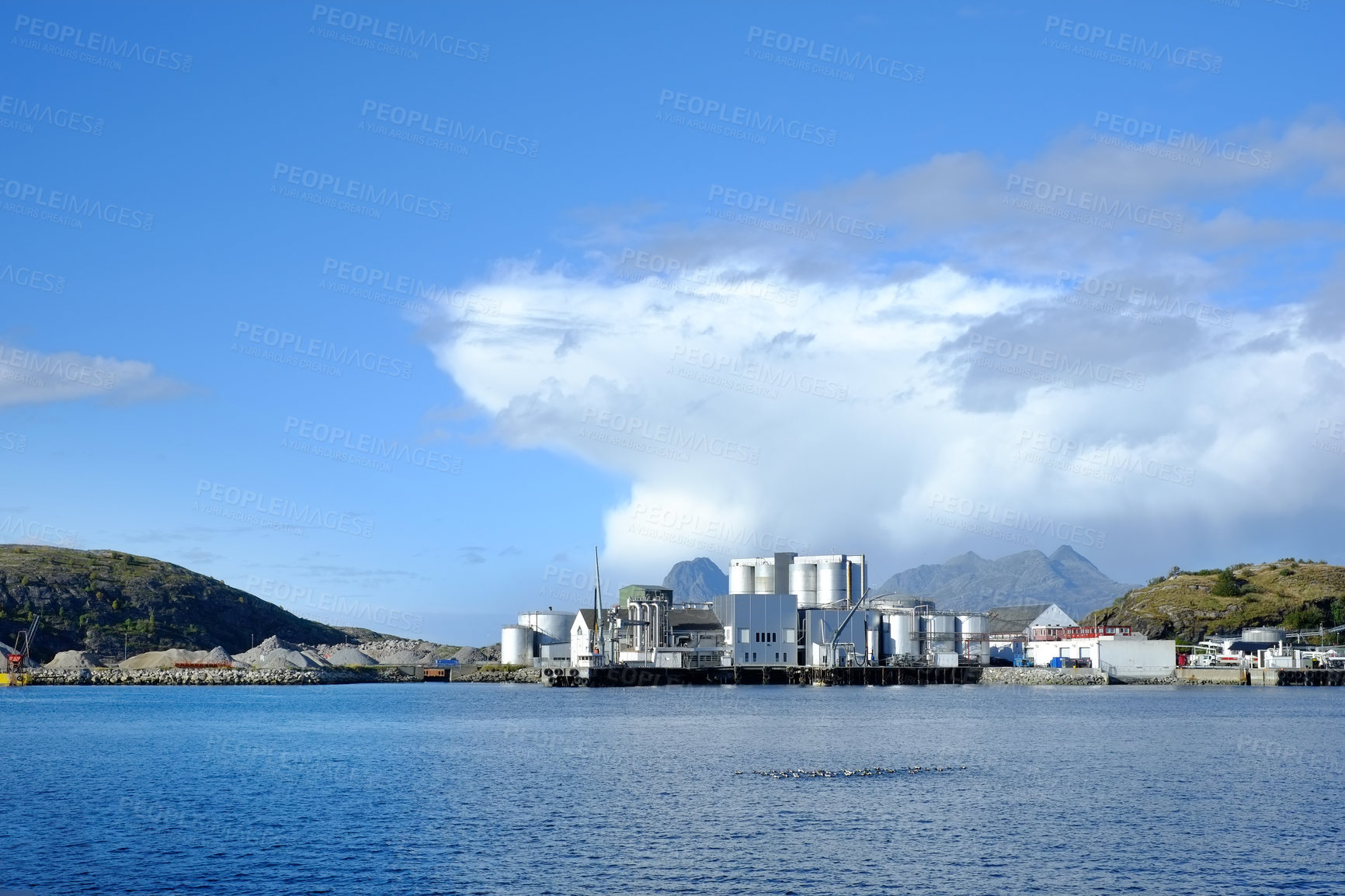 Buy stock photo Outdoor, water and industrial building at harbor for marine engineering, manufacturing or ship maintenance. Sky, sea and warehouse for waste management, pollution control or factory in Netherlands