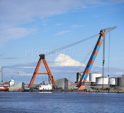 Buy stock photo Supply chain, harbor and industrial crane at port for cargo transport, delivery or distribution. Empty, shipping and machine for logistics, steel manufacturing or infrastructure at export factory