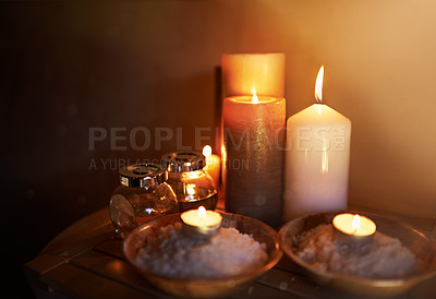 Buy stock photo Spa, candle and oil with salt for meditation in room for peace or luxury with aromatherapy to relax. Aromatic or cosmetic liquid, table and candlelight for mindfulness or wellness and self care.