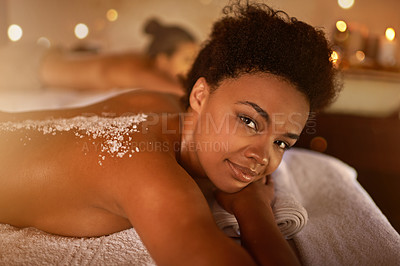 Buy stock photo Salt, spa application and black woman portrait of customer at a hotel with lying for massage. Exfoliate therapy, luxury and relax treatment of a female person back for skincare and wellness 