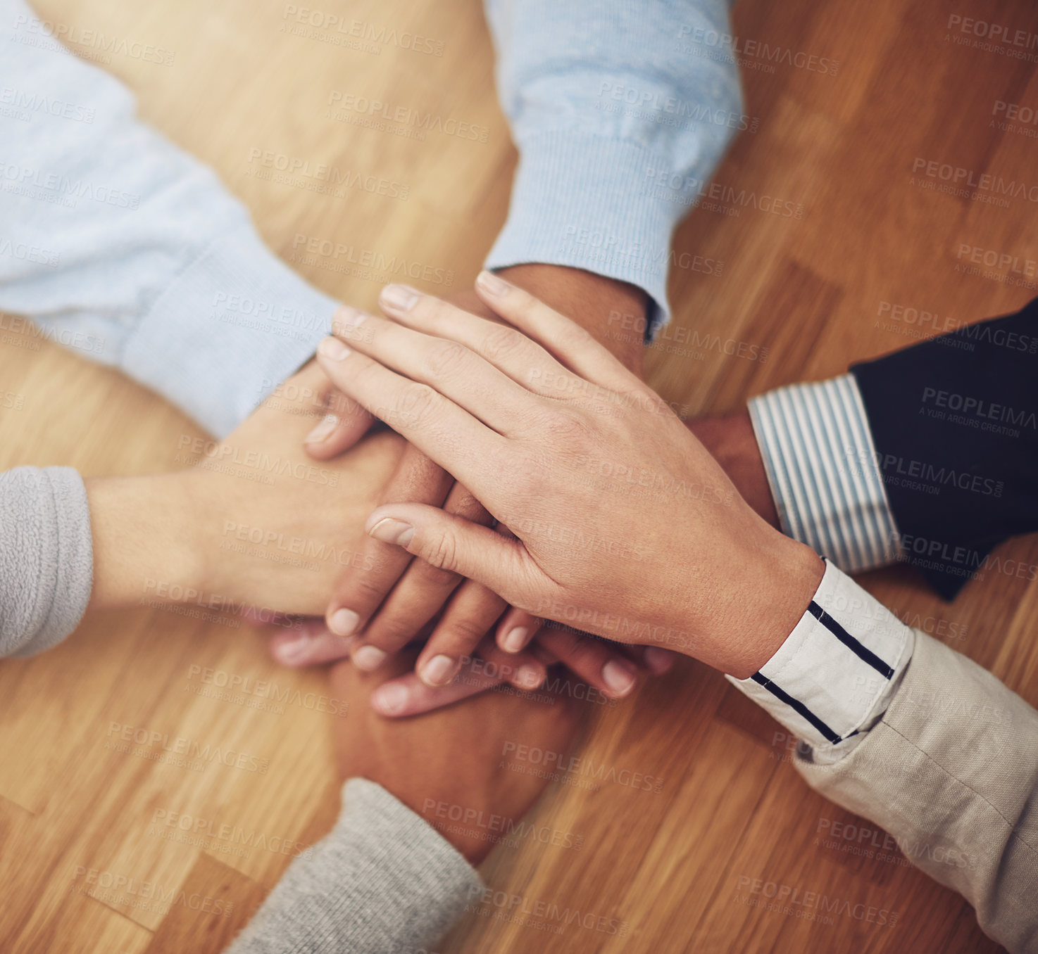 Buy stock photo Cropped shot of a group of businesspeople putting their hands together in unity