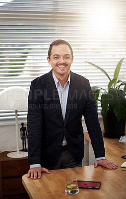 Buy stock photo Portrait, businessman and smile with leaning on desk for corporate job, lens flare and office. Expertise, smiling and face of consultant in workplace with career, standing and advice for clients