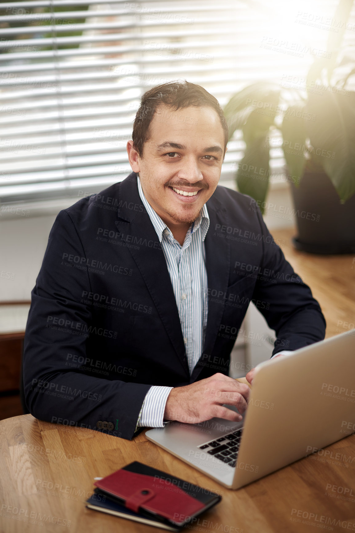 Buy stock photo Smile, laptop and portrait of business man at desk for communication, email or search web. Lens flare, professional and employee with computer for planning, agenda or typing report in office