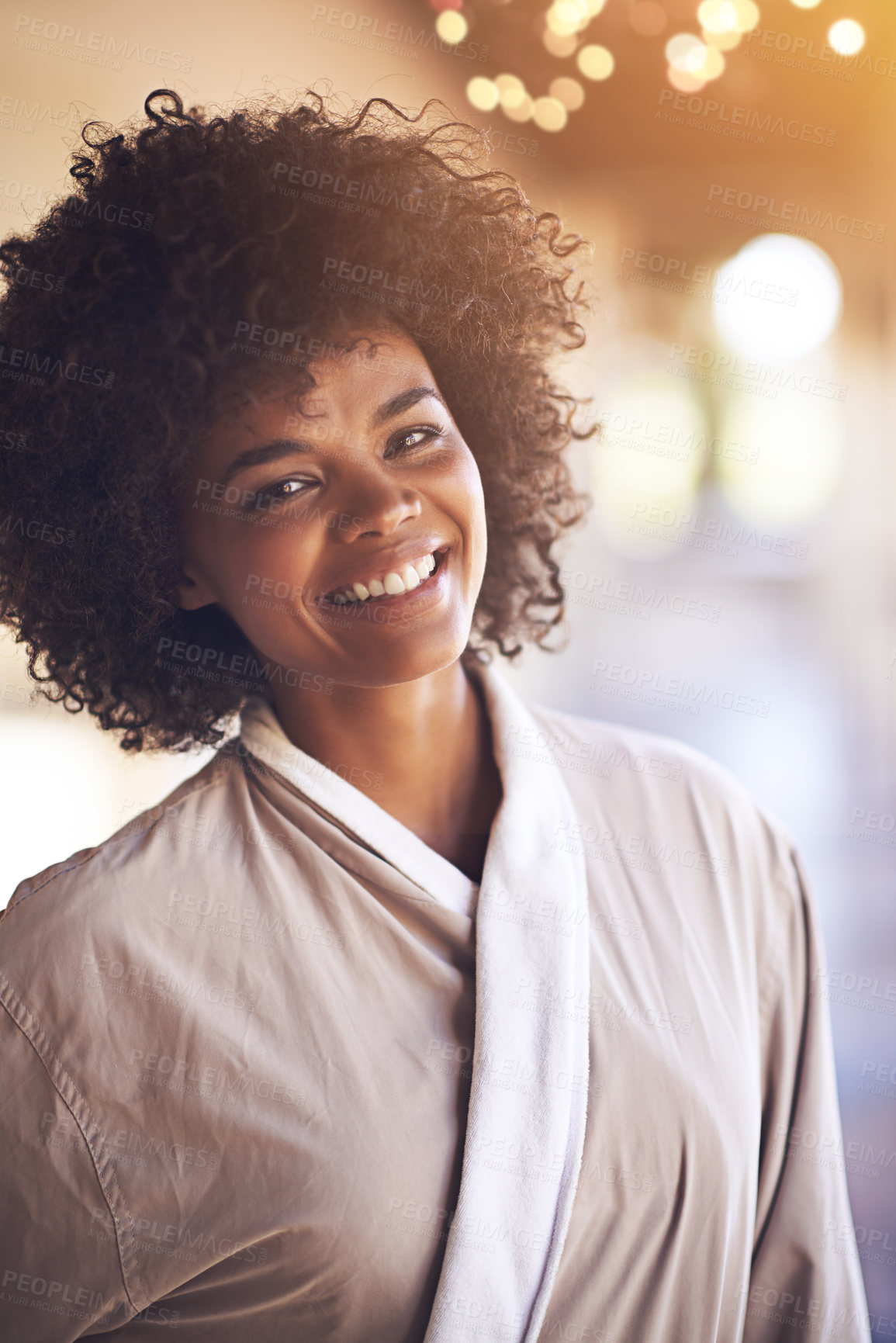 Buy stock photo Spa, woman and portrait with smile in a bathrobe for wellness, cosmetics and beauty treatment. Health, skincare and resort with an African female person ready for dermatology at a hotel with bokeh