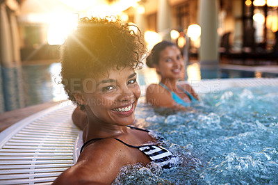 Buy stock photo Portrait of a woman relaxing in a jacuzzi with her friend blurred in the background