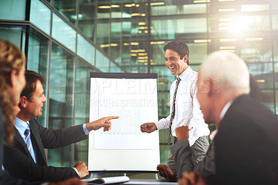 Buy stock photo Cropped shot of a group of businesspeople listening to a presentation