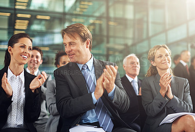 Buy stock photo Cropped shot of a group of businesspeople applauding while sitting in a presentation