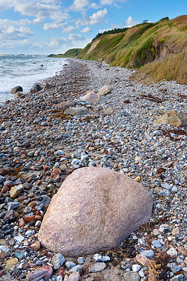 Buy stock photo Coast of Kattegat - Helgenaes, Denmark. Ocean waves washing onto empty beach shore stones. Calm peaceful paradise of summer seascape and sky for relaxing fun holiday abroad or travel vacation