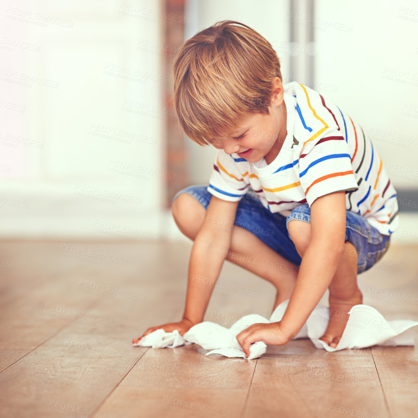 Buy stock photo Boy, floor and cleaning in home for mess, spill or household chores for childhood development. Little boy, toilet paper and maintenance in house with hygiene, housework and learning responsibility