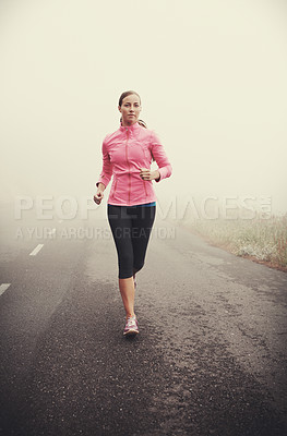 Buy stock photo Nature, fitness and young woman running on mountain road for race, marathon or competition training. Sports, exercise and female athlete with cardio workout in misty outdoor woods or forest.