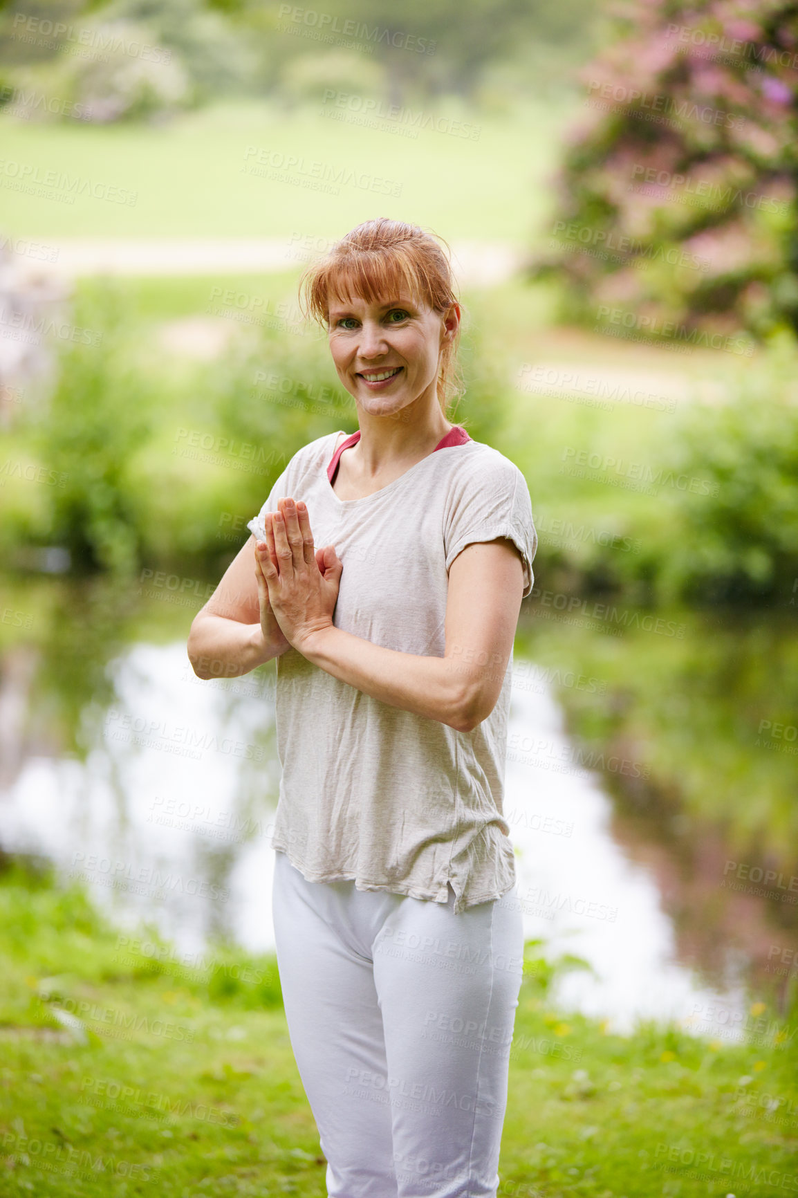 Buy stock photo Shot of a woman doing yoga in the park