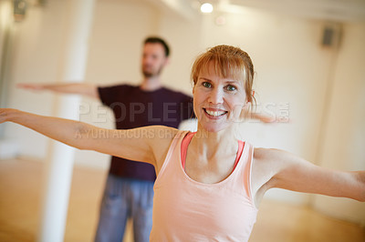 Buy stock photo Shot of two people doing yoga indoors