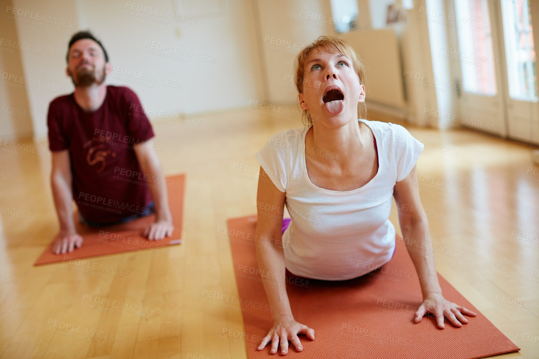 Buy stock photo Shot of two people doing yoga together in a studio