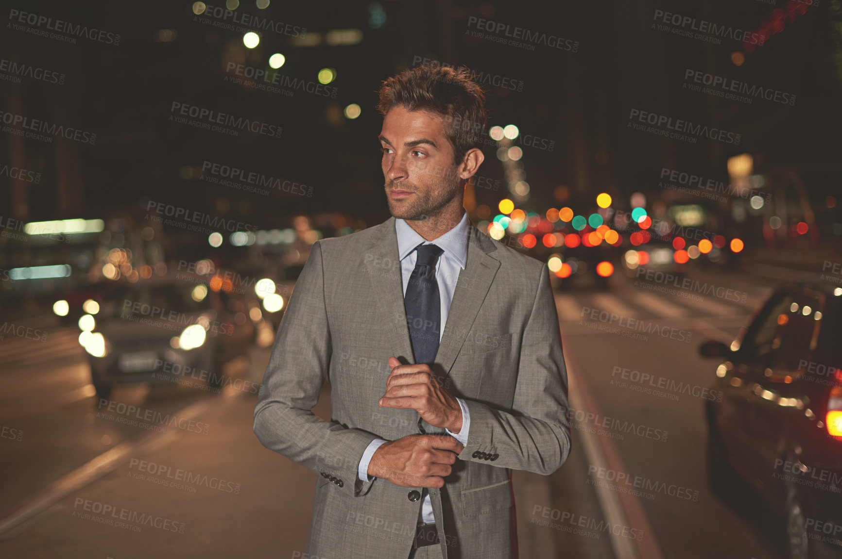 Buy stock photo A handsome businessman in the city at night