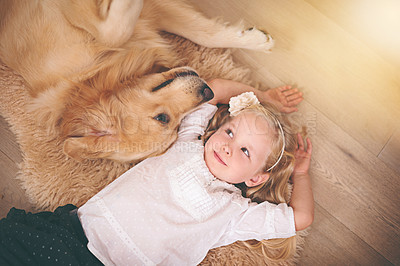 Buy stock photo An adorable little girl with her dog at home