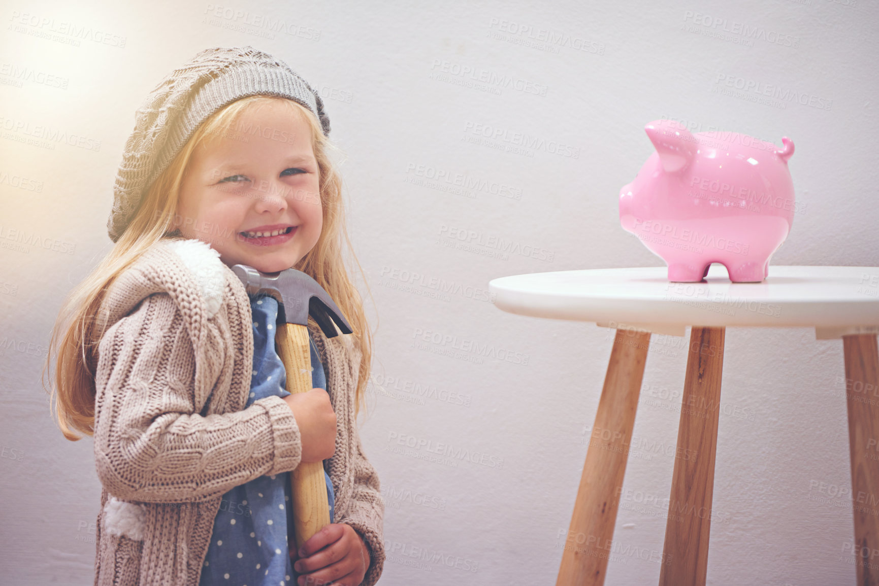 Buy stock photo Girl, hammer and piggy bank for savings in portrait, finance and investment for future in home. Female person, child and waiting for profit or wealth, happy and tool to break a money box to spend