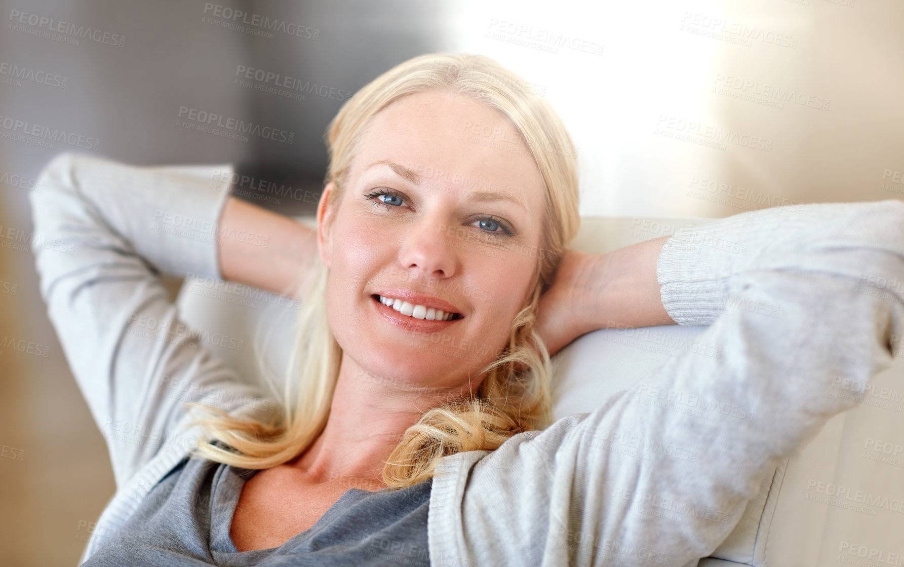 Buy stock photo Happy, woman and relax with stretching on sofa for weekend break, lazy morning and flare. Portrait, person and comfortable with smile in home for rest, day off and peaceful afternoon in living room