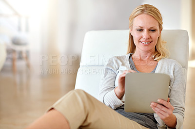 Buy stock photo Happy woman, tablet and smile in living room for social media, research or browsing on chair at home. Female person smiling and relaxing on technology for communication or online search at the house