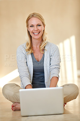 Buy stock photo Portrait of a woman using a laptop while sitting on her living room floor