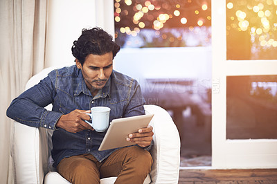 Buy stock photo Tablet, coffee and man on sofa in living room for online blog on social media, app or internet. Reading, web and male person drinking cappuccino and scroll on digital technology in lounge at home.