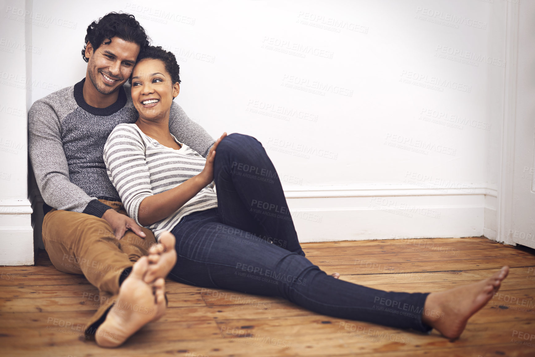 Buy stock photo Couple, floor and touch for care and love in home, smile and proud of marriage and commitment. People, affection and relax in living room on weekend, support and trust or bonding in relationship