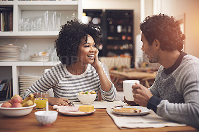 Buy stock photo Shot of a couple eating breakfast together at home