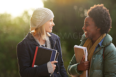 Buy stock photo College, books and conversation with woman friends outdoor on campus together for learning or development. Education, school or university with young student and best friend talking at recess break