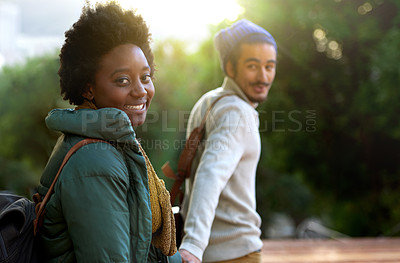 Buy stock photo Holding hands, park and happy interracial couple together with smile, bag and morning commute to university. College, students and romance in nature, man and woman with diversity, mockup and love.