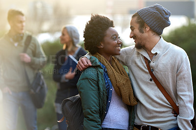 Buy stock photo Students, university and conversation of interracial couple of friends on campus with hug and an embrace outdoor. College, school education and diversity with a happy smile ready for class together