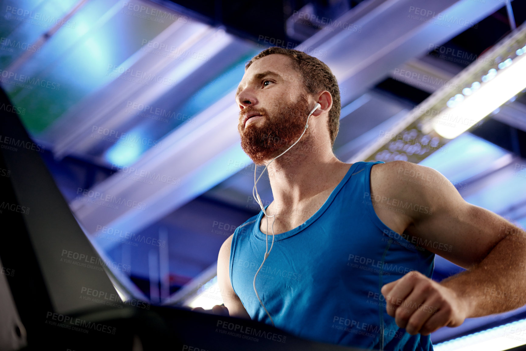 Buy stock photo Earphones, fitness and man running on treadmill in gym for health, wellness and body weight loss. Exercise, runner and male athlete with cardio workout on machine for race training in sports center.