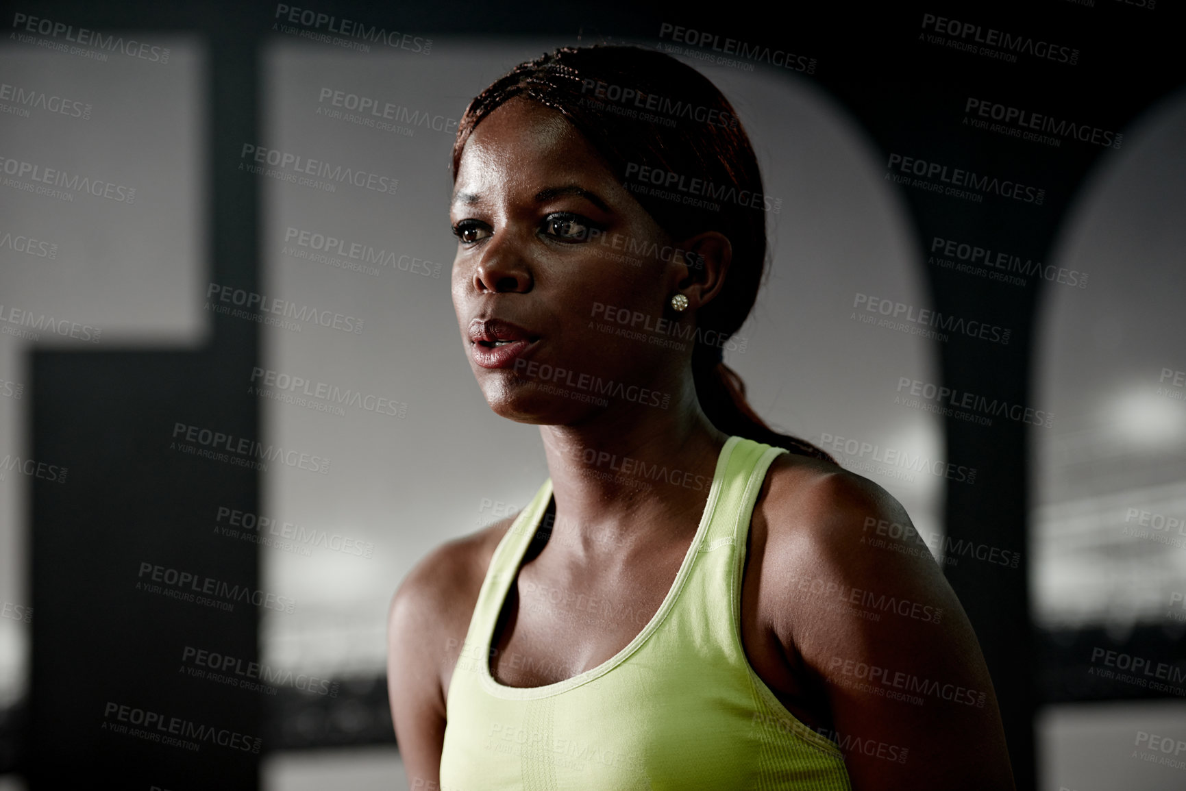 Buy stock photo Shot of a young woman standing inside a gym