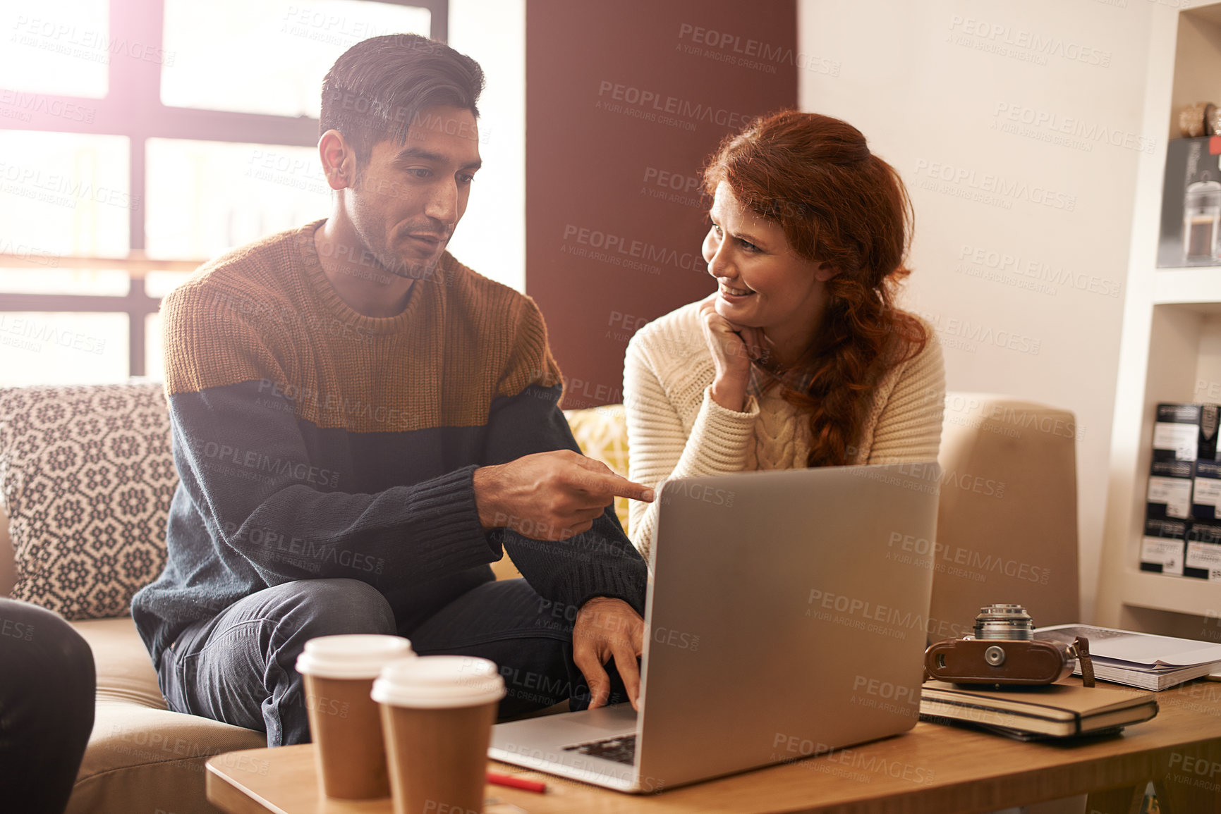 Buy stock photo Young couple, laptop and break in coffee shop for latte drinks, love and bonding together on weekend. Man, woman and computer for photography editing on social media update and cappuccino in cafe