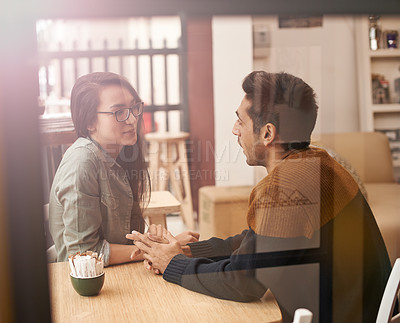 Buy stock photo Couple, relax and talking with date at cafe for conversation or enjoying romance at indoor restaurant. Young man and woman by window at coffee shop for social, chatting or romantic bonding together