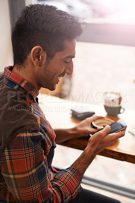 Buy stock photo Happy man, coffee and typing with phone for social media, communication or networking at indoor cafe. Male person on mobile smartphone with smile for online chatting, texting or app at restaurant