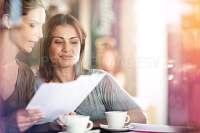 Buy stock photo People, reading and meeting at cafe with paperwork, proposal or women problem solving together. Business, collaboration and conversation in coffee shop with feedback on review or advice for report