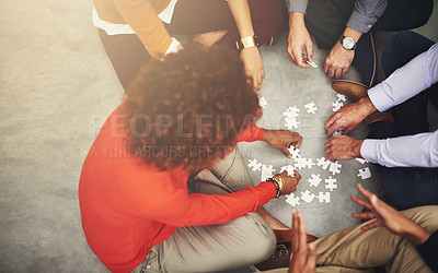 Buy stock photo Puzzle, love and family hands in home on weekend for bonding together with teamwork on floor. Synergy, group and aerial view of people in circle with problem solving game in collaboration at house.