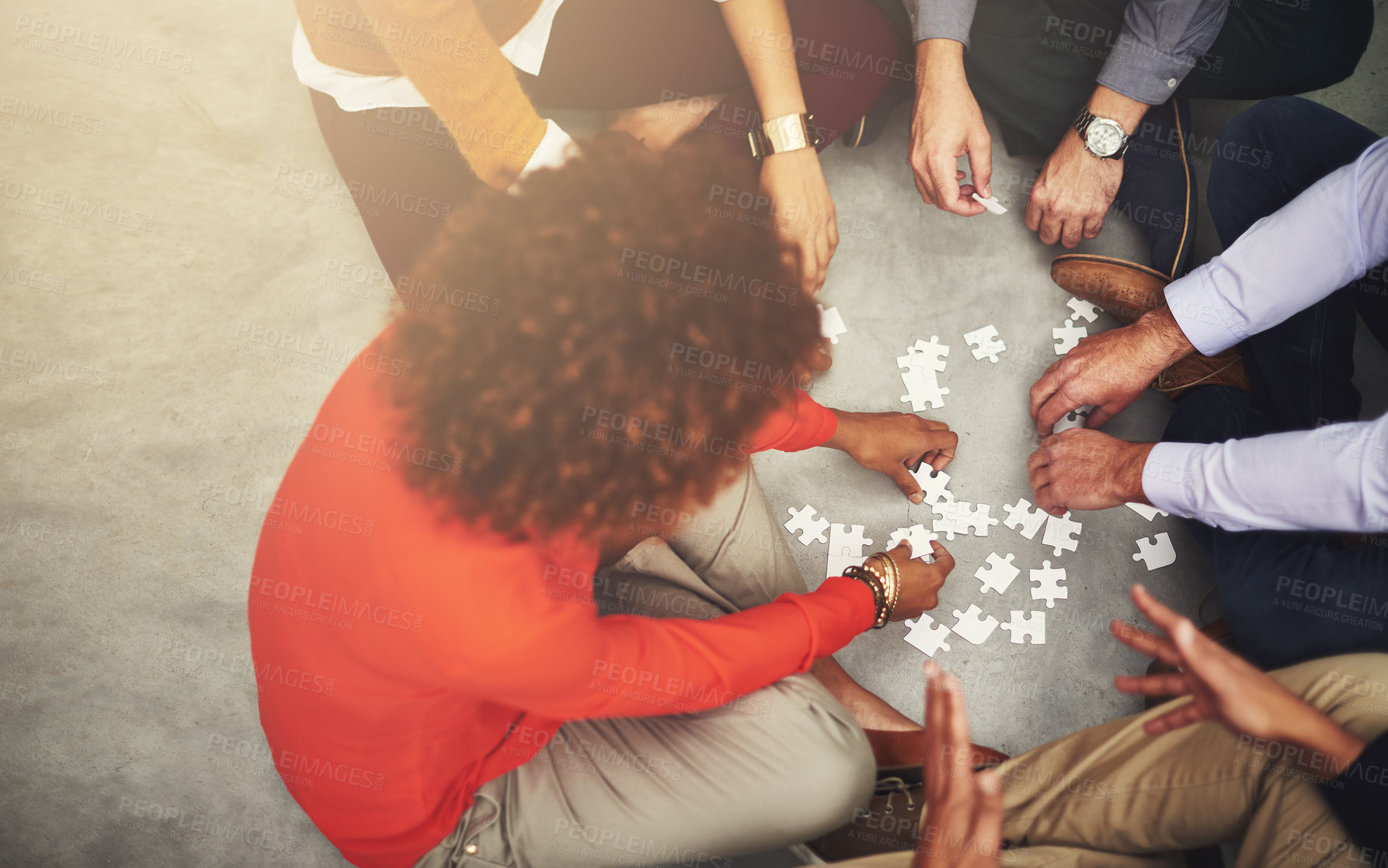 Buy stock photo Puzzle, love and family hands in home on weekend for bonding together with teamwork on floor. Synergy, group and aerial view of people in circle with problem solving game in collaboration at house.