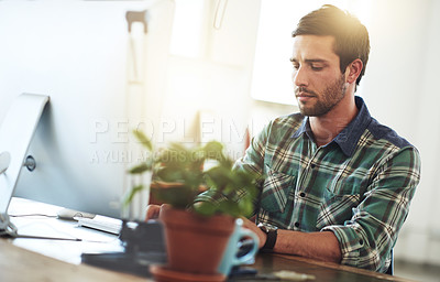 Buy stock photo Shot of a designer working at his computer