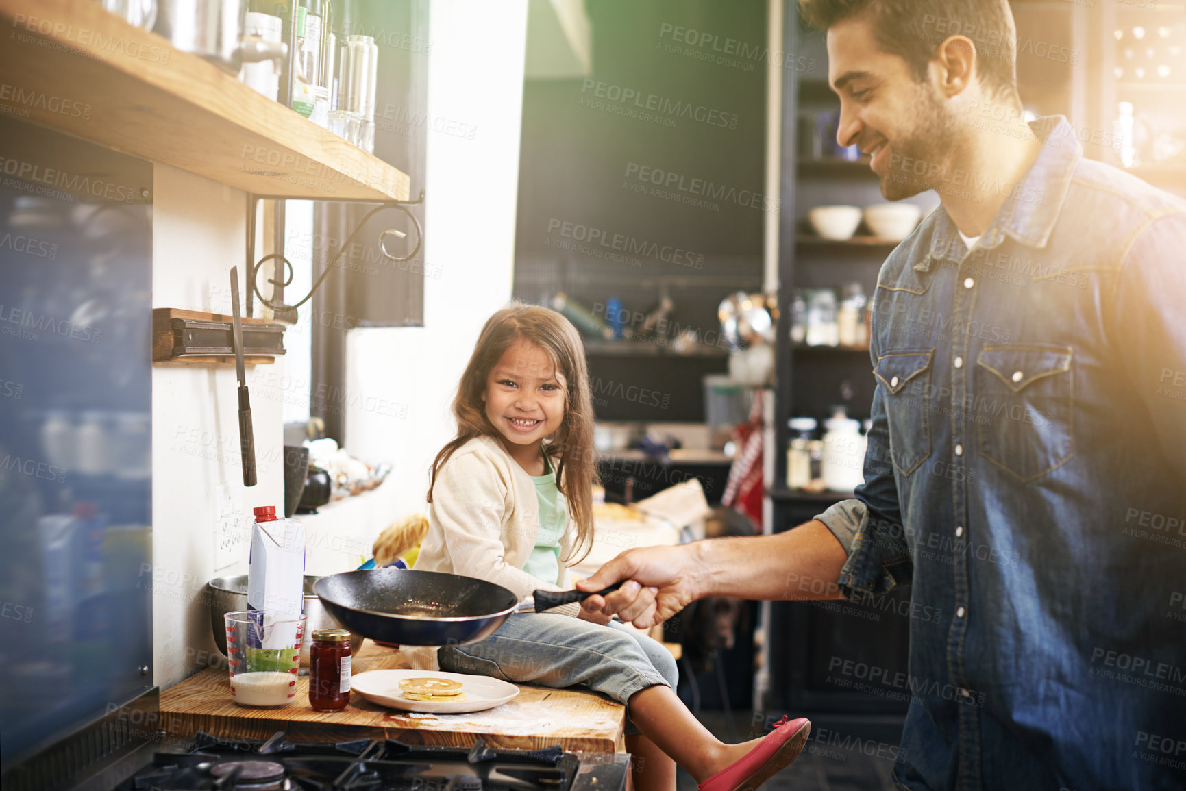 Buy stock photo Shot of a father and daughter making pancakes together