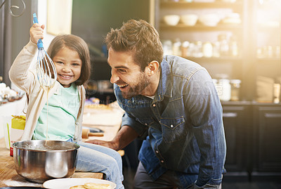 Buy stock photo Shot of a father and daughter making pancakes together