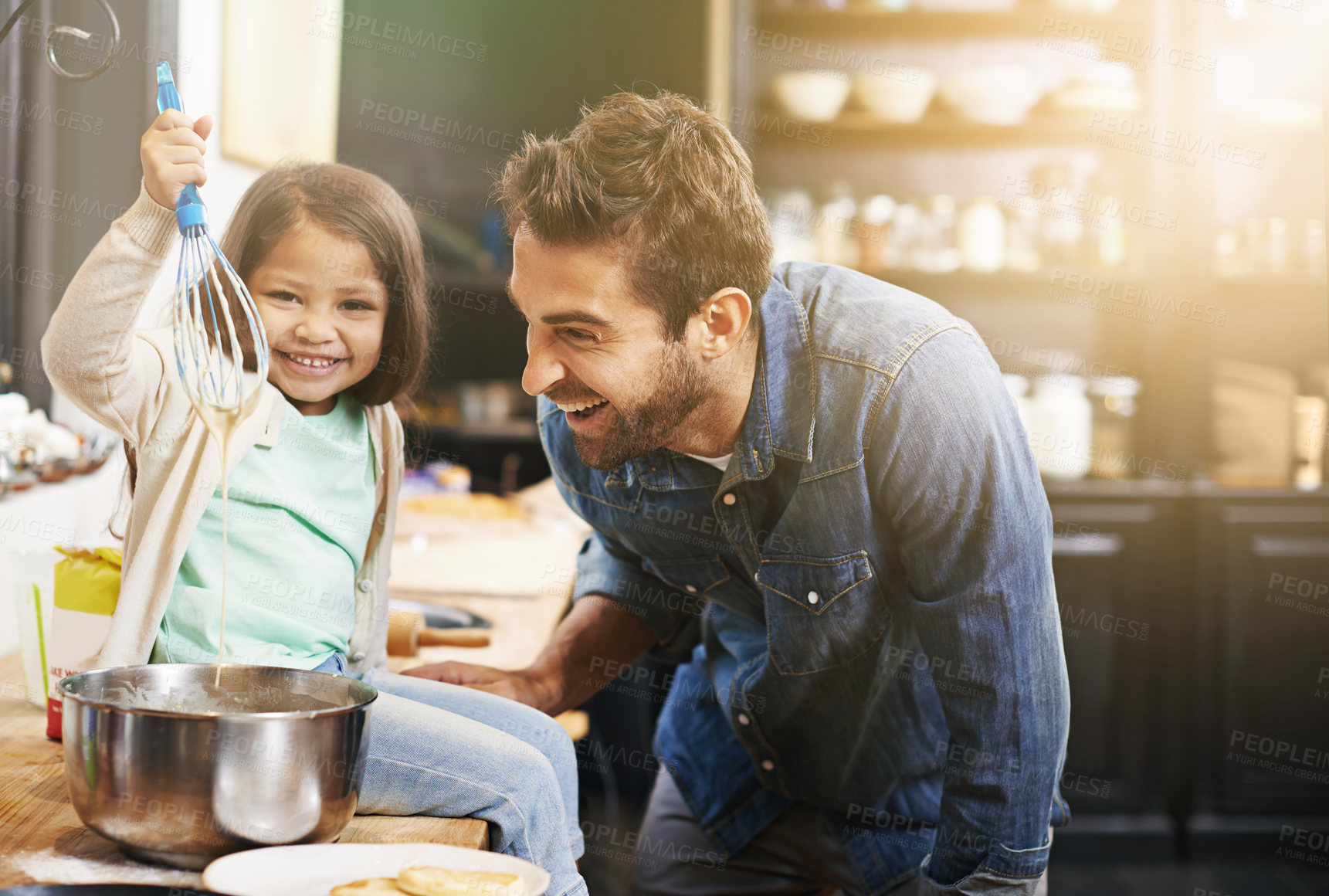 Buy stock photo Shot of a father and daughter making pancakes together