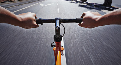 Buy stock photo POV shot of a person riding a bicycle along a road