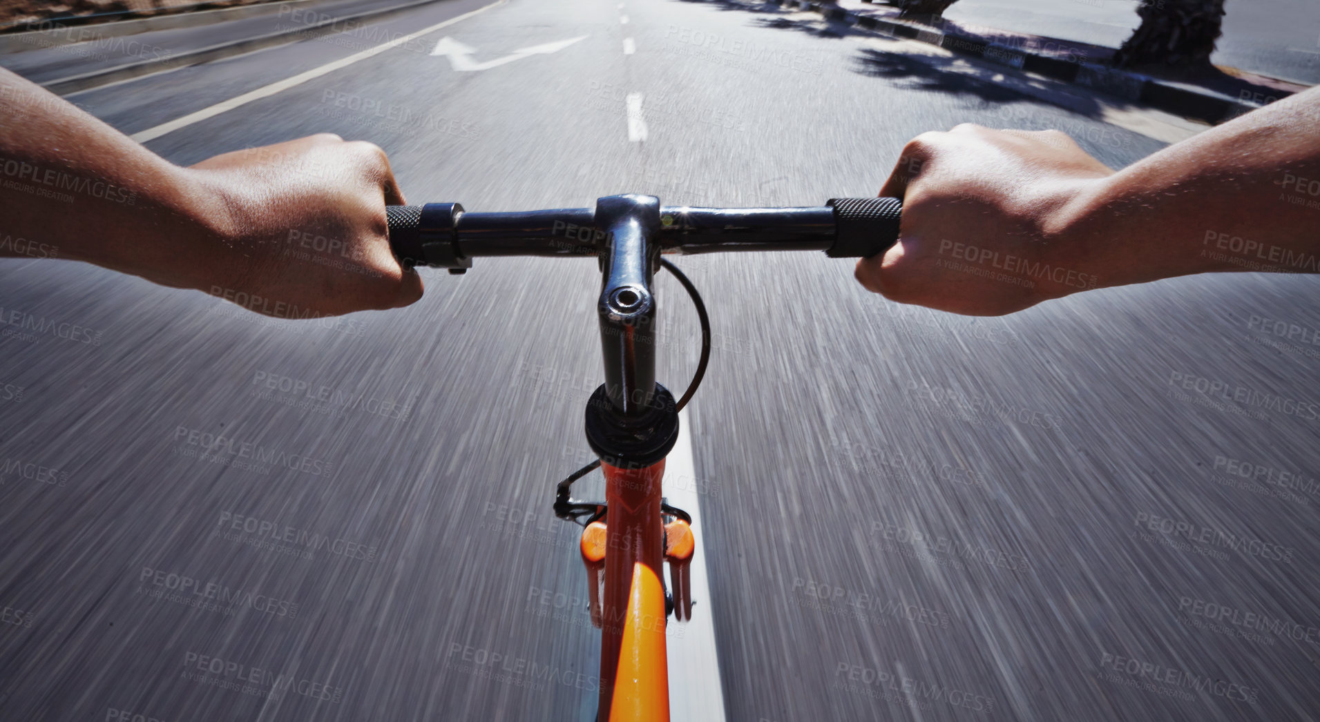 Buy stock photo POV shot of a person riding a bicycle along a road