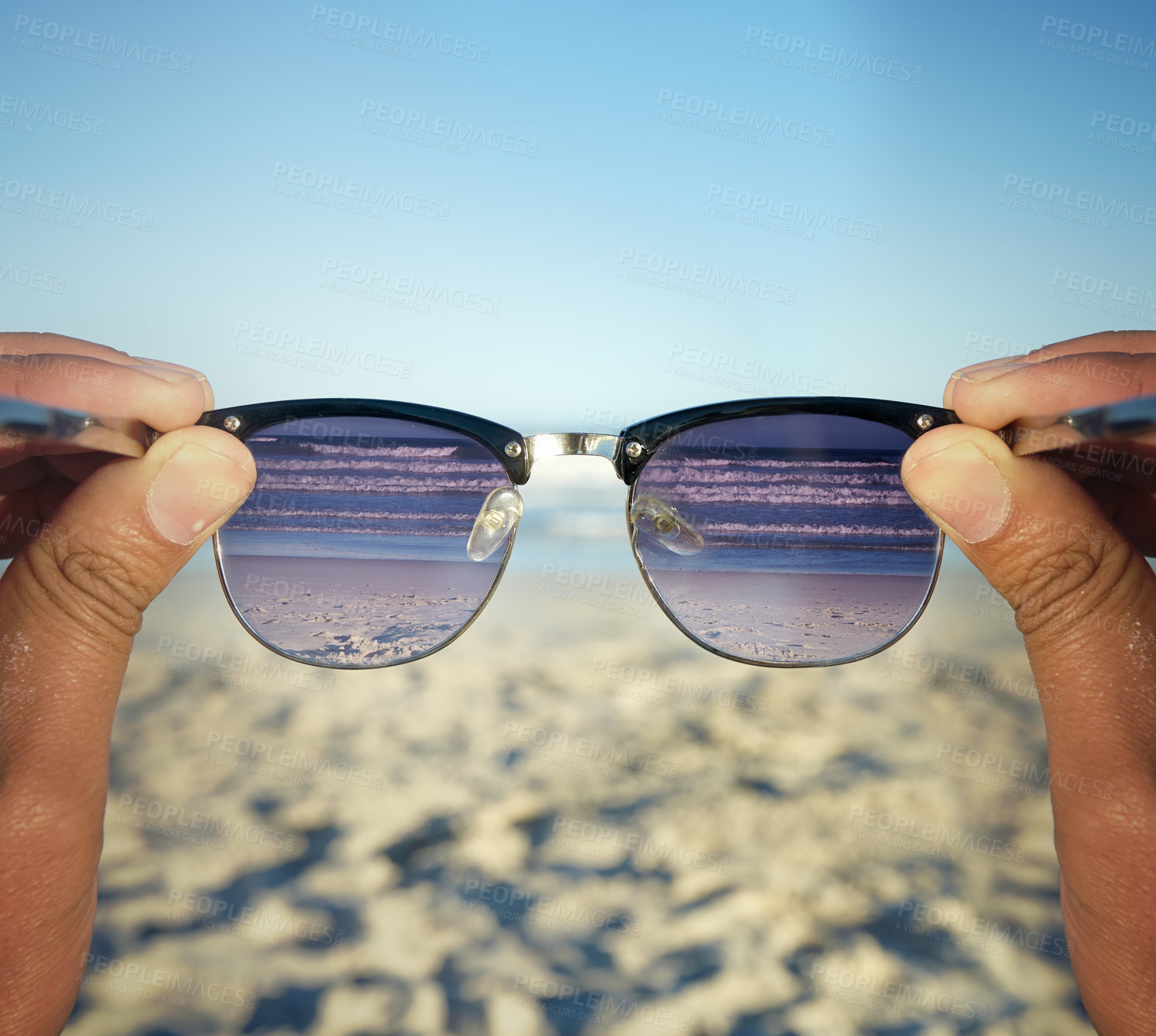 Buy stock photo POV shot of a person at the beach looking at the waves through their sunglasses