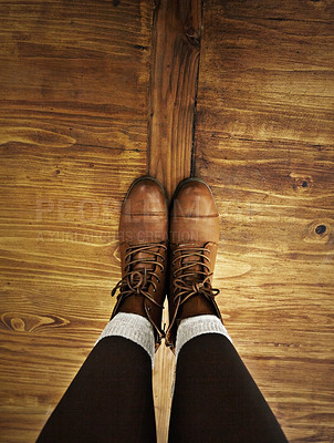 Buy stock photo POV of a person wearing boots while standing on a wooden floor. Top view of one person's legs and brown leather ankle shoes on old wood flooring in autumn or winter fashion style