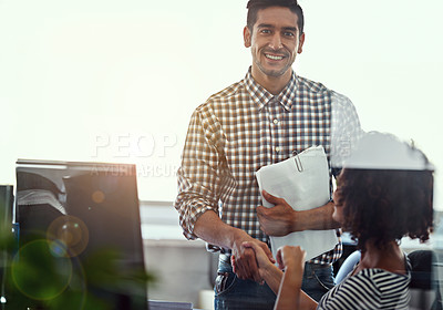 Buy stock photo Cropped shot of two colleagues shakng hands in the office