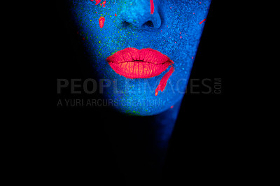 Buy stock photo Shot of a young woman posing with neon paint on her face